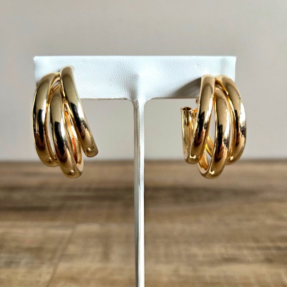 Gold tone large triple loops clip on earrings.